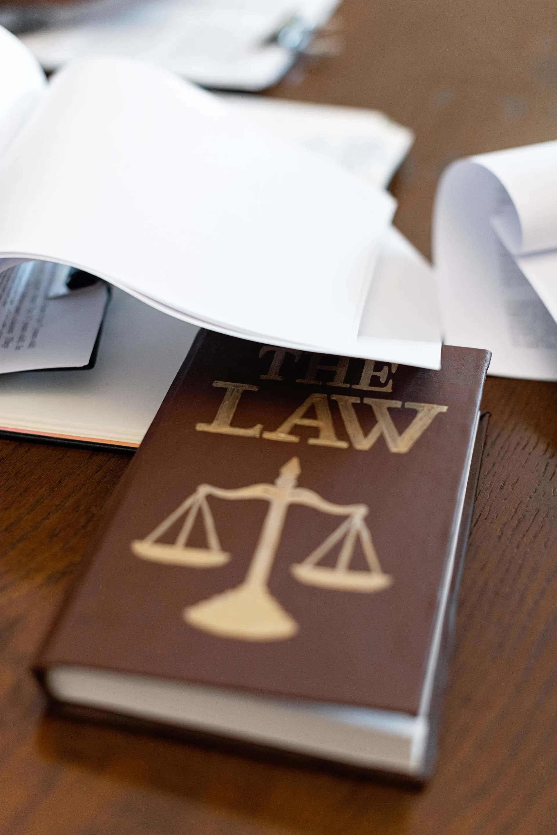 Documents and a law book on a desk